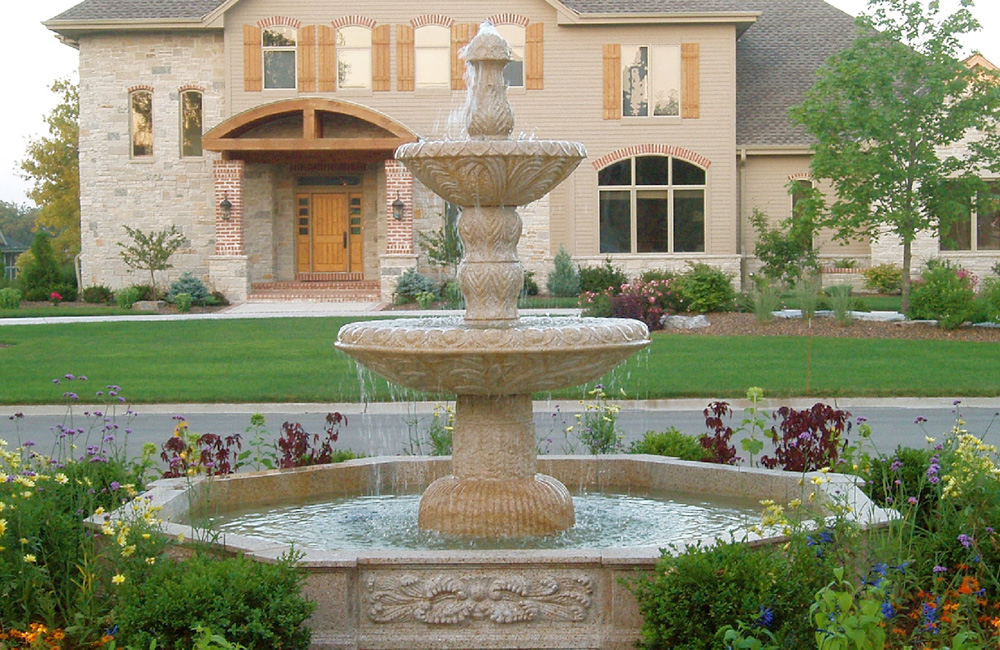 48 inch diameter x 79 inch tall 2-Tier Egg Dart fountain in a 10 Ft. Diameter Octagonal Relief Carved Pool Surround, with both items carved of giallo fantasia granite.