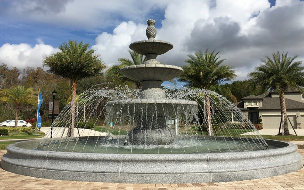 3-Tier Playa Vista Fountain in a 20 Ft Diameter Flared Contour Pool surround, carved of Bianco Catalina Granite with a 16 Ft diameter Copper Spray Ring with 75 adjustable nozzles.