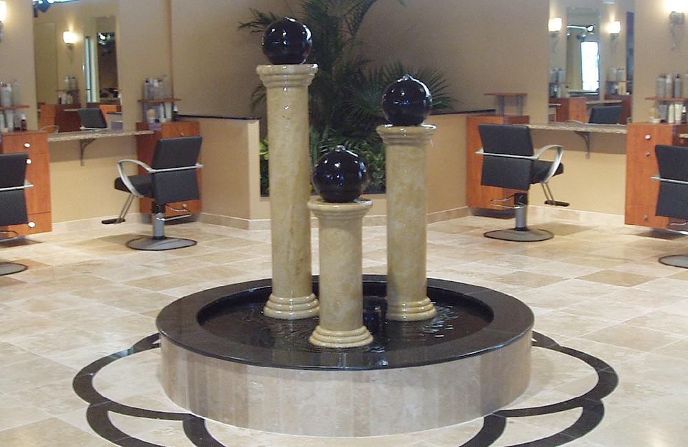 Absolute black granite bubbling sphere fountains in a local hair care shop.