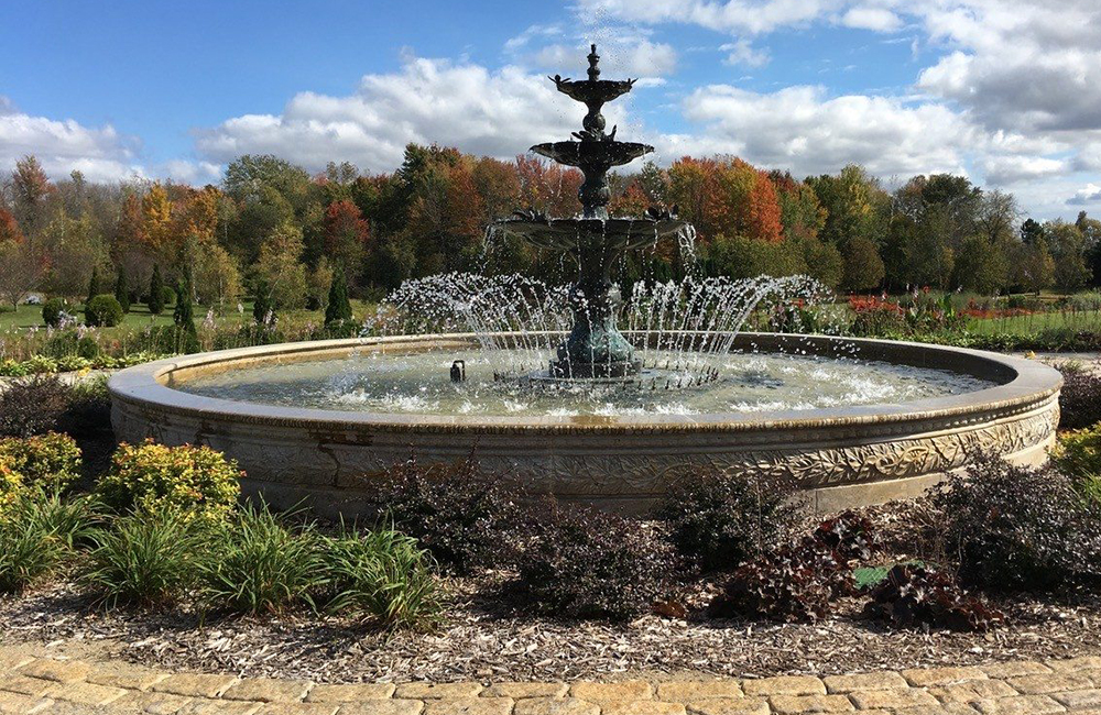 3-Tier Bronze Fountain with Bird decorations in a 20 Ft Diameter x 18 inch Tall Relief Carved Pool Surround with an unusual Outwards Facing Copper Spray ring.