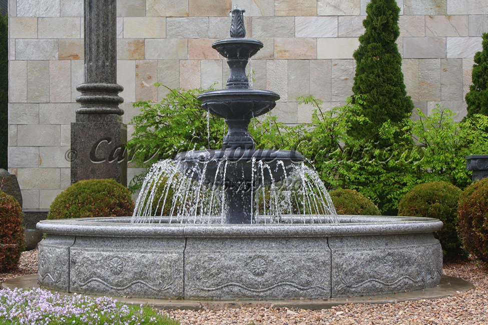 3-Tier Contemporary Spitter Fountain carved of charcoal grey granite, in a 10 Ft Diameter x 18 inch tall relief carved Bianco Catalina Granite Pool Surround