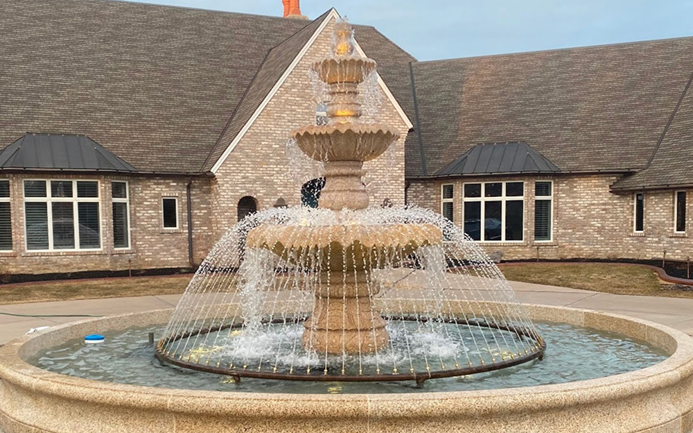 Tall 3-tier Classical fountain (72 x 126" tall) in a 20' Diameter x 18" Tall Flared Contour Pool Surround, with both items carved of giallo fantasia granite. Also includes a 12' diameter copper spray ring with (90) adjustable nozzles.