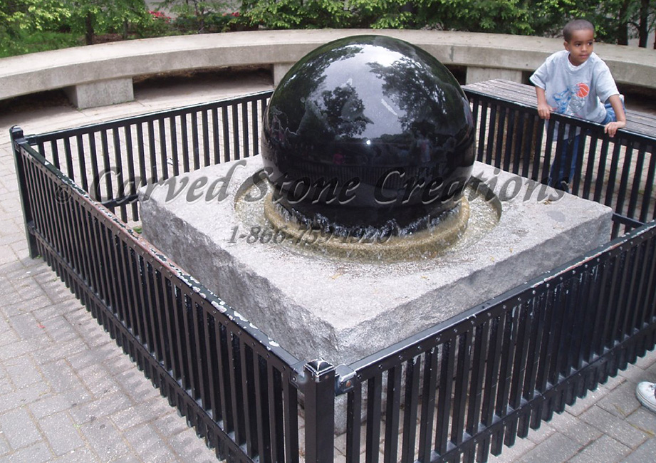 Absolute Black Granite Rolling Sphere fountain with Bianco Catalina Granite Rockfaced Base.