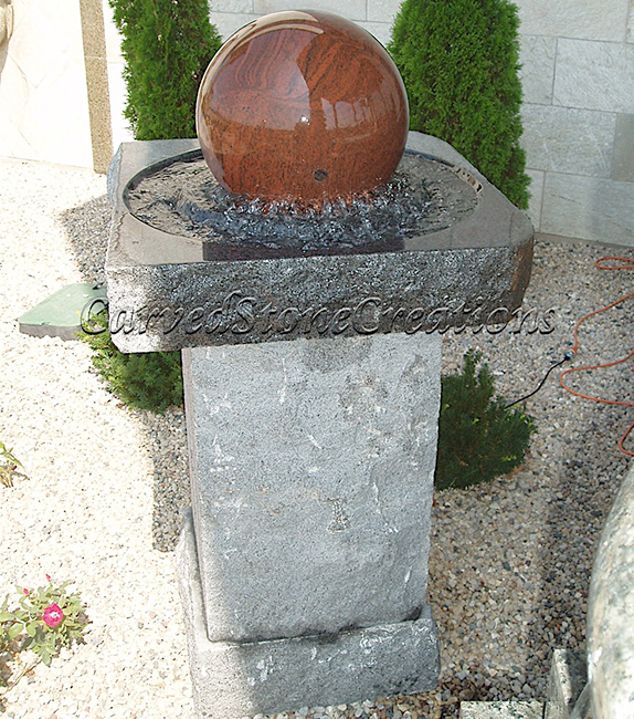 Granite Rolling Sphere fountain in a Rockfaced Granite Base