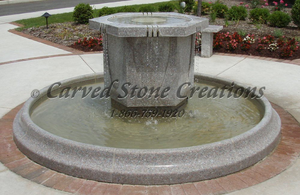 Contemporary Hexagonal Fountain centerpiece in a small Round Pool Surround, carved of Wild Rose Granite.